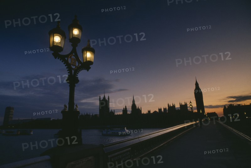 ENGLAND, London, The Houses of Parliament at sunset seen across Westminster Bridge