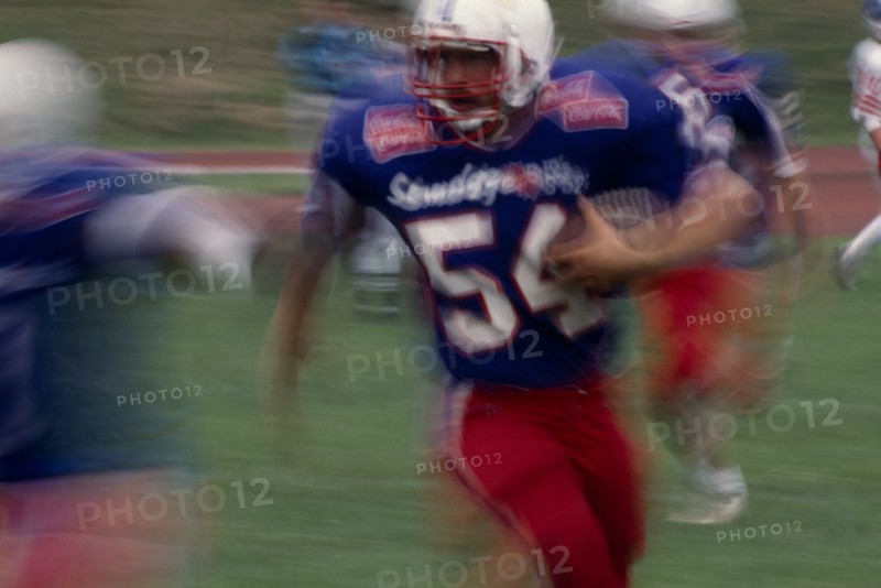 20025666 SPORT Ball Games American Football Blurred action shot of the Brighton B-52s quarter back running with the ball
