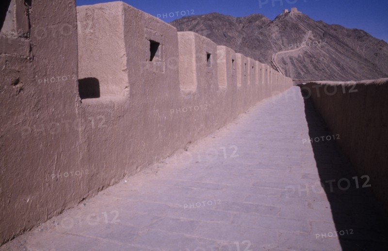CHINA, Gansu, Jiayuguan, The Great Wall. View along the path and crenellated wall leading toward hillside