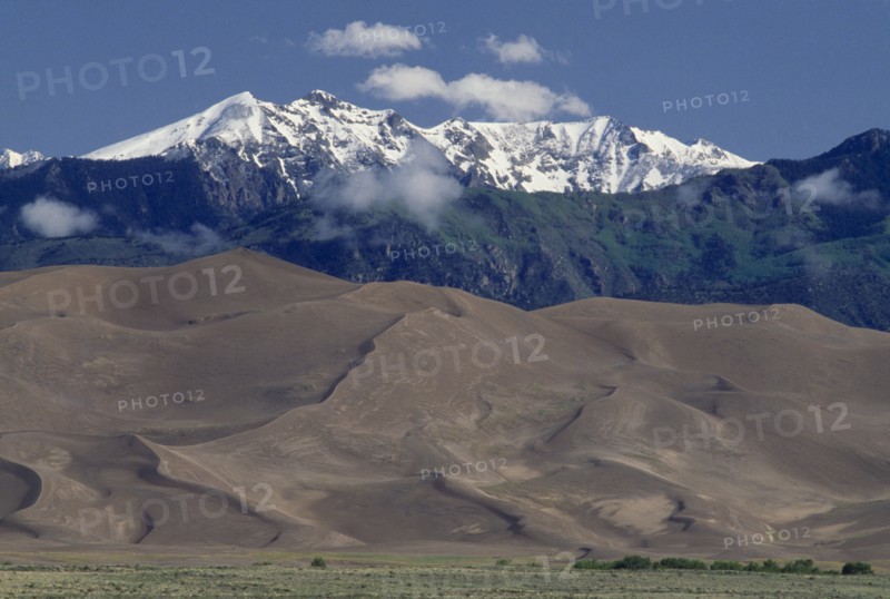 USA, Colorado, Saguache, Great Sand Dunes National Monument. Snow capped mountain landscape behind sand dunes
