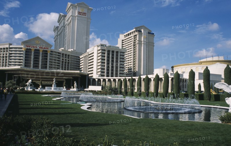 USA, Nevada, Las Vegas, Caesar’s Palace hotel and casino with lawns and fountains in the foreground