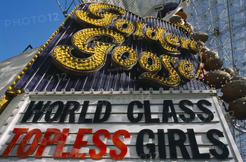 USA, Nevada, Las Vegas, Golden Goose strip joint ‘ Topless Girls ‘ sign in Fremont street covered downtown area