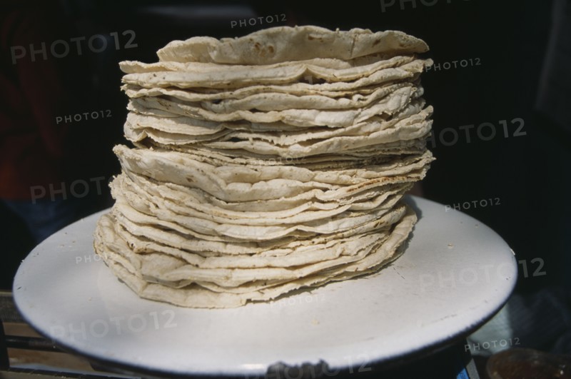 MEXICO, Mexico City, Stack of tortillas on white plate.