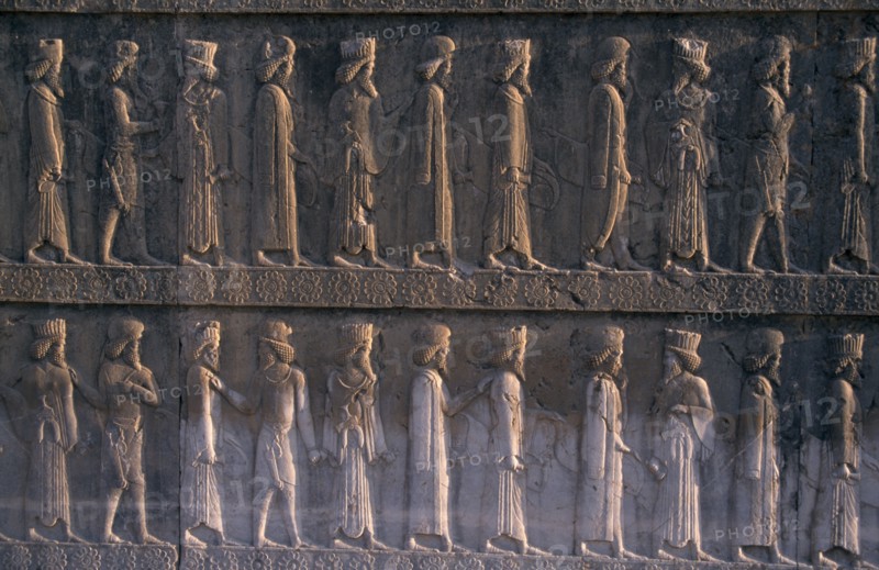 IRAN, South, Persepolis, Fifth century BC Archaemenid palace complex.  Detail of relief carving on the eastern section of the Apadana stairway depicting diginitaries of the realm paying tribute.