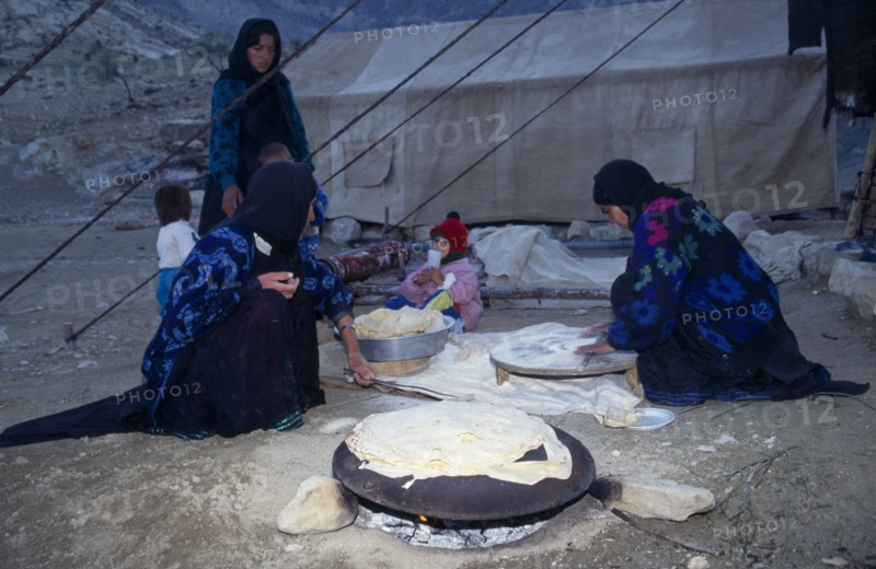 IRAN, Zagros Mountains, Qashqai nomad family making bread at a camp in the Zagros Mountains.