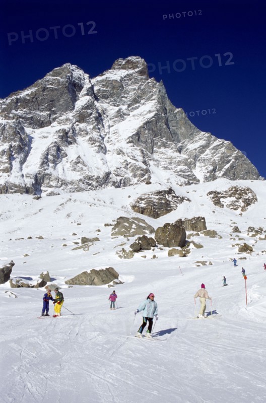 ITALY, Valle d’Aosta, Breuil Cervina, Skiers on the slopes of the Matterhorn ski range.