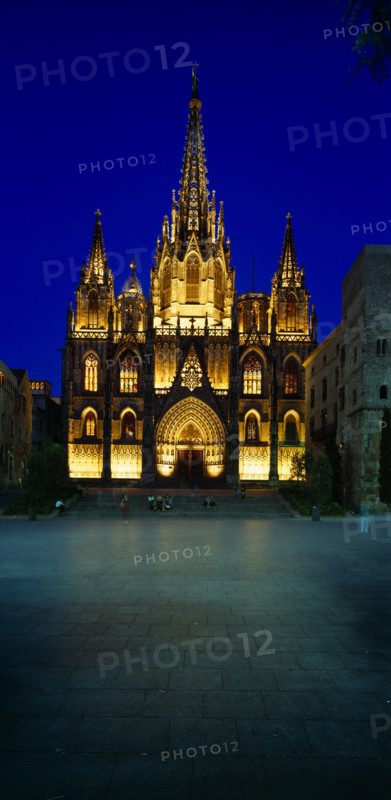 SPAIN, Catalonia, Barcelona, The Cathedral.  Exterior facade and entrance illuminated at dusk.