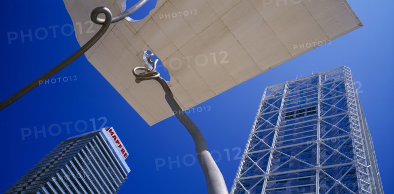 SPAIN, Catalonia, Barcelona, Torre Mapfre and Hotel Arts Barcelona seen from below looking up against blue sky.