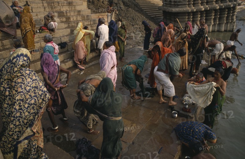 INDIA, Uttar Pradesh, Varanasi, People gathered on the ghats and bathing in the River Ganges