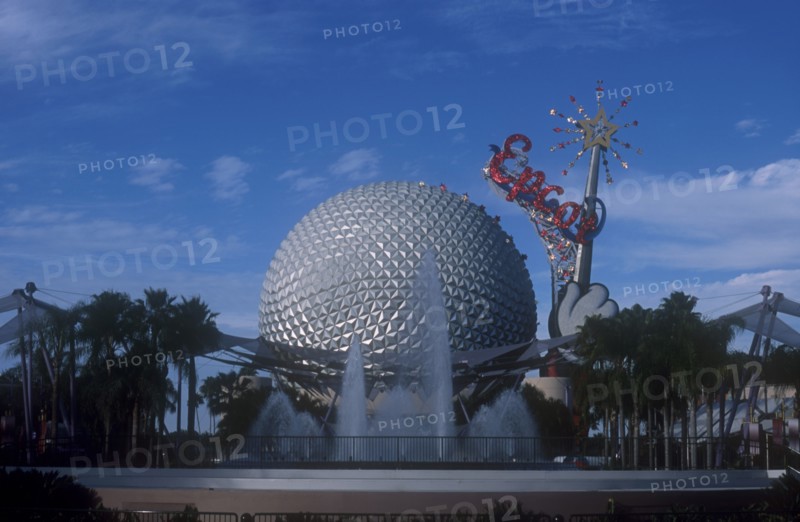 USA, Florida, Orlando, Walt Disney World Epcot. View of the Spaceship Earth with sparkling red Epcot sign and fountain at the base.