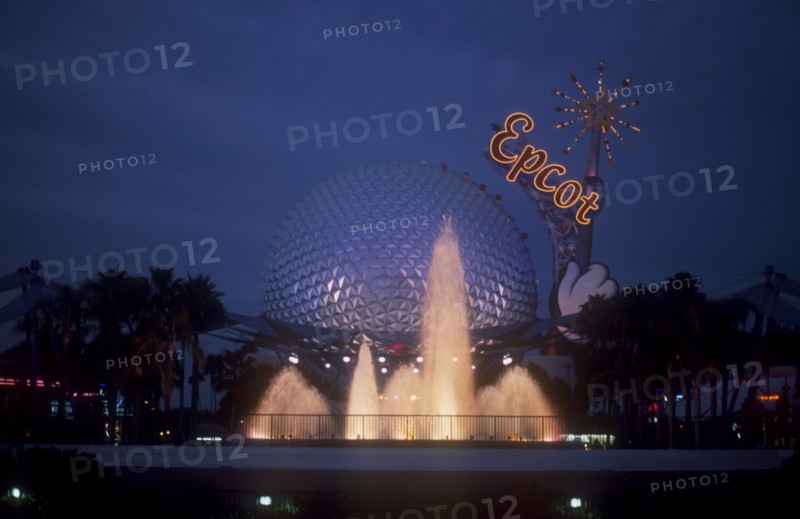 USA, Florida, Orlando, Walt Disney World Epcot. View of the Spaceship Earth with  Epcot sign and fountain illuminated at dusk.