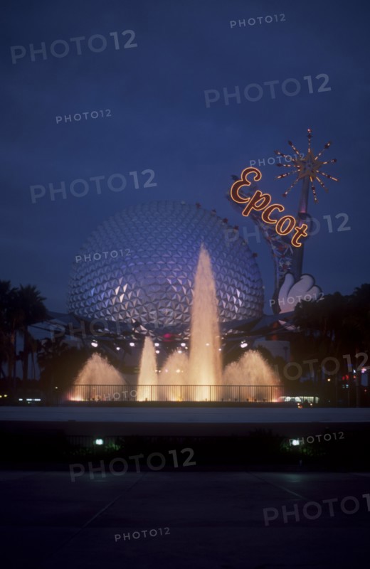 USA, Florida, Orlando, Walt Disney World Epcot. View of the Spaceship Earth with  Epcot sign and fountain illuminated at dusk.