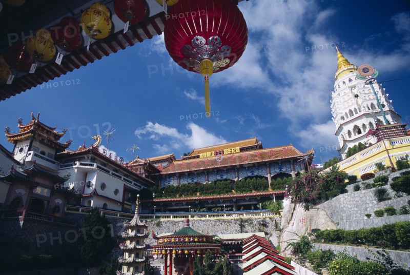 MALAYSIA, Penang, Kek Lok Si Temple, "General view of the temple complex with Ban Po, the Pagoda of a Thousand Buddhas on the right. Part framed by overhanging roof with red Chinese lantern "