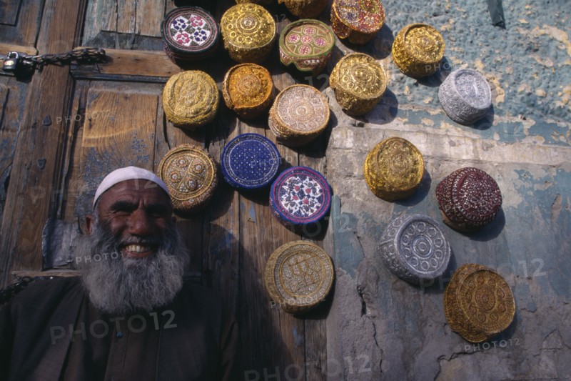 PAKISTAN, Baluchistan, Quetta  , Vendor with display of muslim caps for sale.