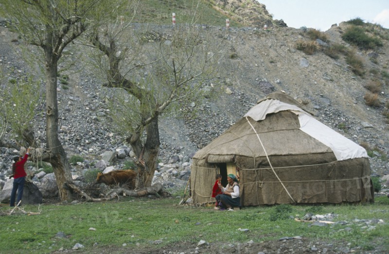 CHINA, Xinjiang , Tianchi, "Kazakh Yurt, tent, with women and young boy outside"