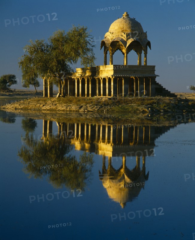 INDIA, Rajasthan, Jaisalmer, Gadi Sagar Tank.  Building reflected in water.