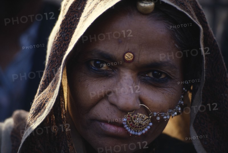 INDIA, Rajasthan, Portrait of woman wearing nose to ear jewellery.