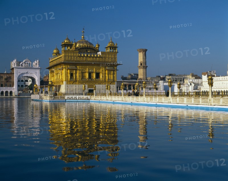 INDIA, Punjab, Amritsar, The Golden Temple with reflection in lake in foreground.