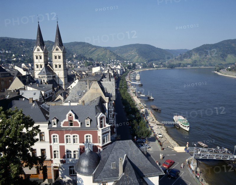 GERMANY, Rhineland, Boppard, Town beside River Rhine. Building with twin towers. Boats moored at pontoons.