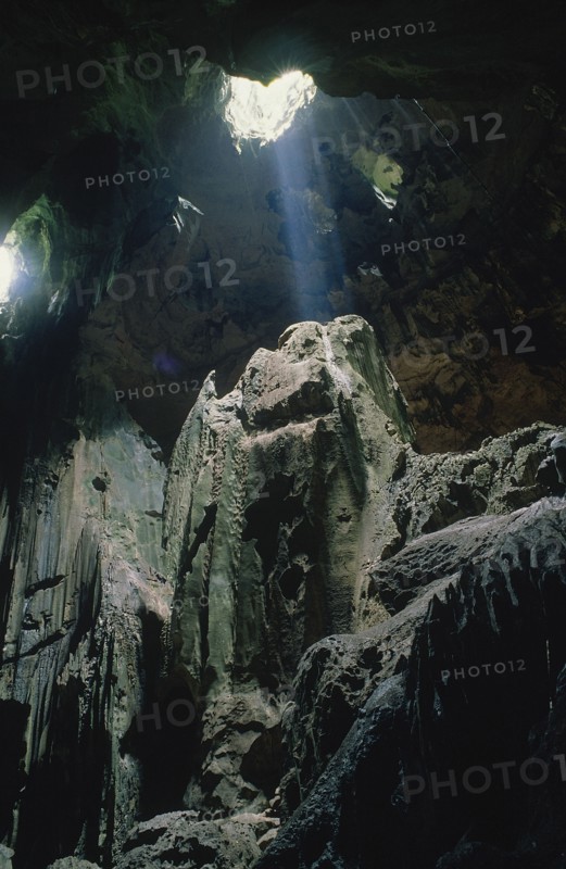 MALAYSIA, Borneo, Kalimantan, Niah Caves interior with light shining through holes in the roof of the cave