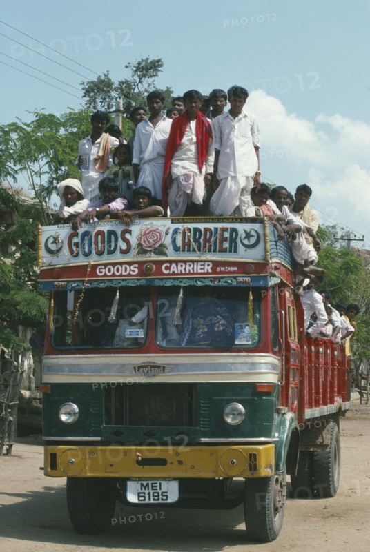 INDIA, Karnataka, Transport, Goods Carrier truck crowded with passengers.