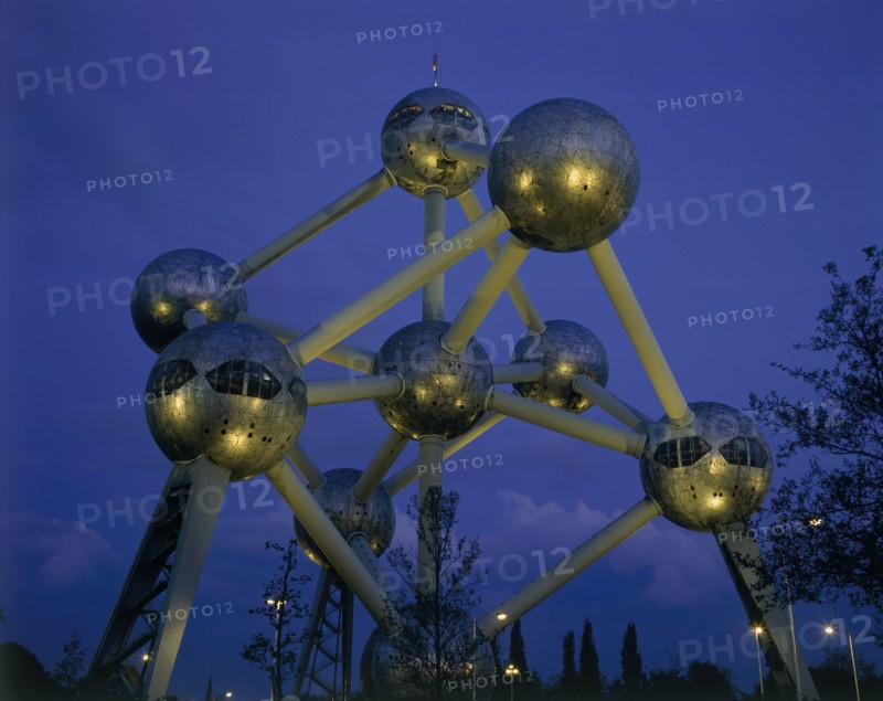 BELGIUM, Brabant, Brussels, The Atomium illuminated at night with lights reflected on the base of the metal spheres