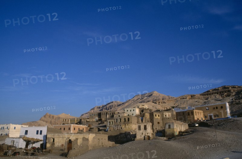 EGYPT, Upper Egypt, Old Qurna, General view of the village buildings with hills behind