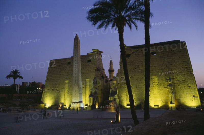 EGYPT, Upper Egypt, Luxor, The Temple Pylons with Obelisk and statues of Ramesses II illuminated at night