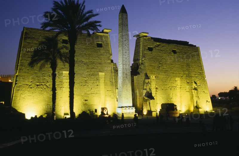 EGYPT, Upper Egypt, Luxor, The Temple Pylons with Obelisk and statues of Ramesses II illuminated at night