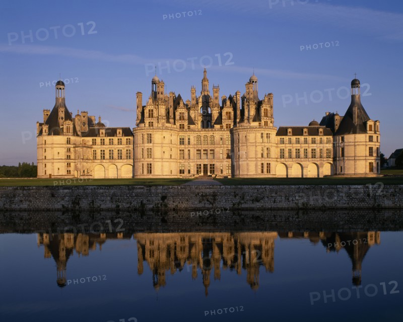 FRANCE, Loire Valley Centre, Loir et Cher, "Chateau Chambord in golden light, reflected in moat in foreground"