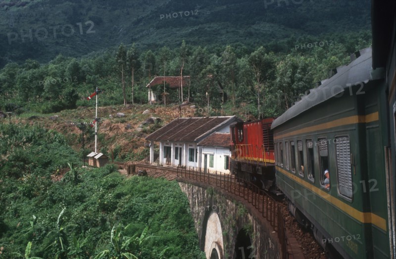 VIETNAM, Hai Van Pass , View from train along carriages as it crosses a bridge surrounded by lush vegetation