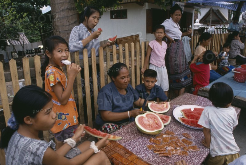 LAOS, Luang Prabang, Family group eating watermelon