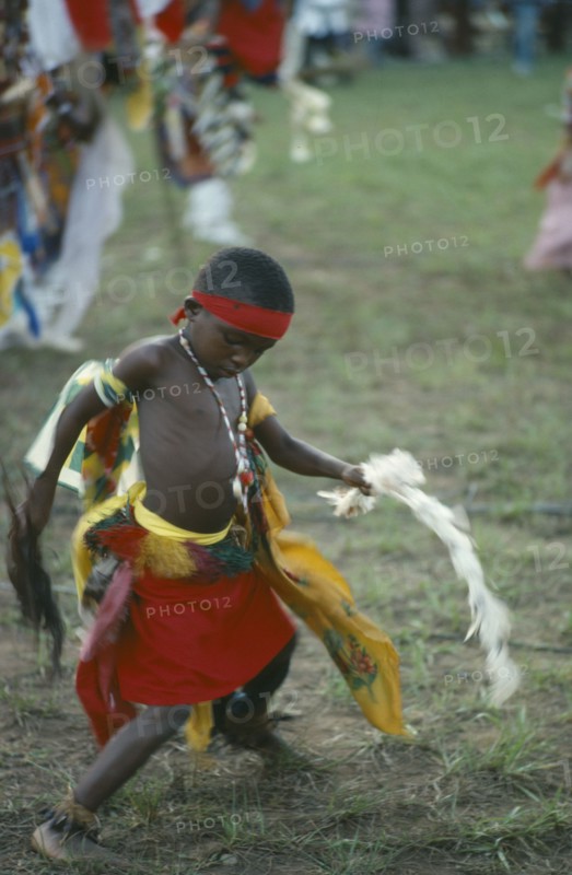 NIGERIA, Festivals, Young Igbo boy in traditional dress dancing