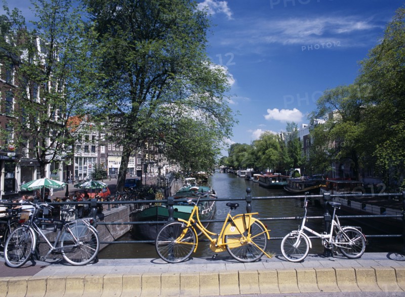 HOLLAND, Noord, Amsterdam, Bicycles leaning against the railings of a bridge over the Prinsengracht canal