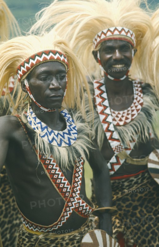 RWANDA, Tribal Peoples, Tutsi dancers wearing lion mane head dresses.