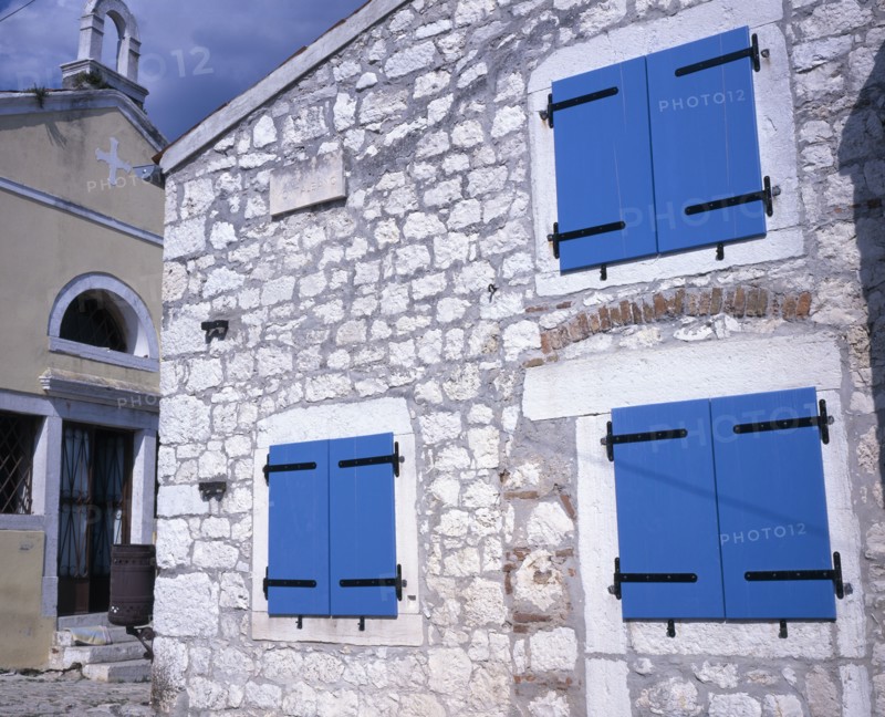 CROATIA, Rovinj, Old town church and cottage with blue painted shuttered windows