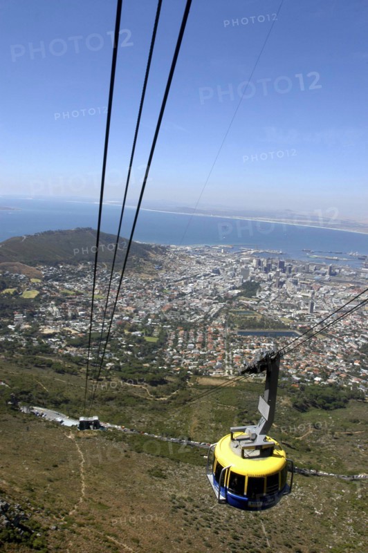 SOUTH AFRICA, Western Cape, Cape Town, Aerial view of cable car high above the city with views of the coastline beyond