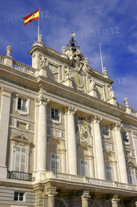 SPAIN, Madrid, Angled view looking up at the Palacio Real facade with the Spanish flag flying from the rooftop