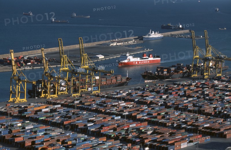 SPAIN, Catalonia, Barcelona, Container port with ships and cranes.