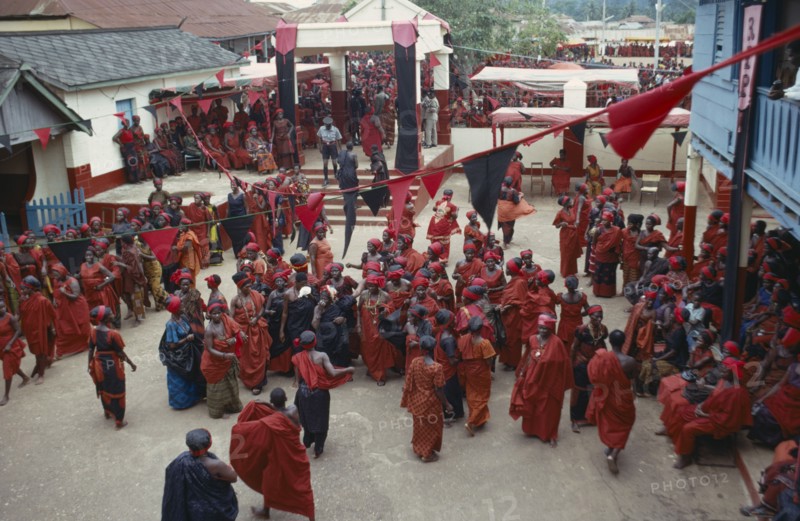GHANA, People, Ashanti, View looking down on group of Ashanti people gathered at a funeral dressed in red the colour of mourning
