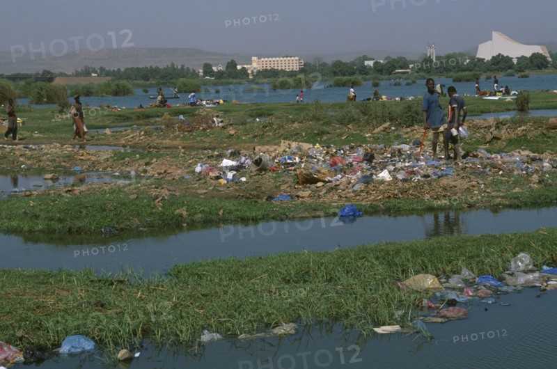 MALI, Bamako, View over the city across a rubbish tip and River Niger with people scavenging  amongst the waste.