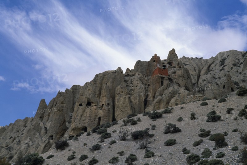 NEPAL, Mustang, Lori Gompa Caves  with small red building atop