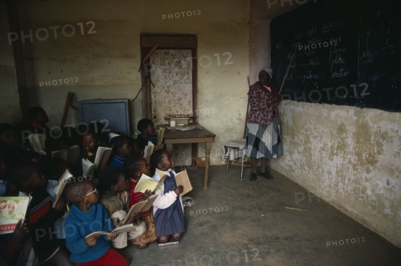 LESOTHO, Education, St Catherines School.  Classroom with pupils and teacher pointing to blackboard.