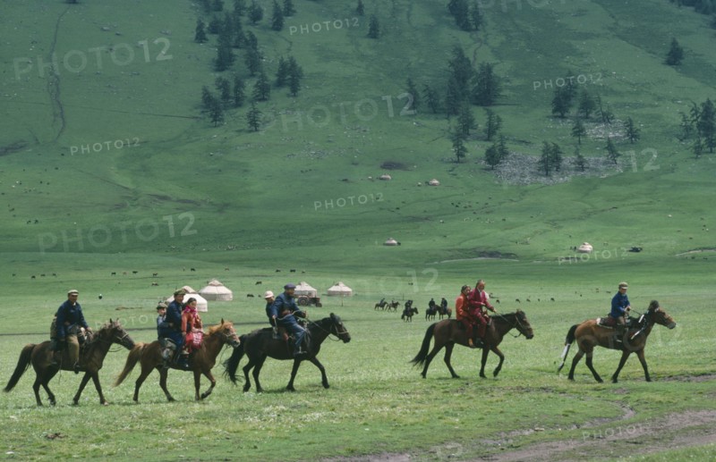 CHINA, Xinjiang Province, Kazakhs, Kazakh people on horseback on their way to the horse races