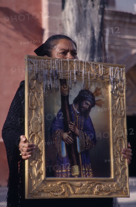MEXICO, San Miquel de Allende, Mourner carrying portrait of Christ at Good Friday procession