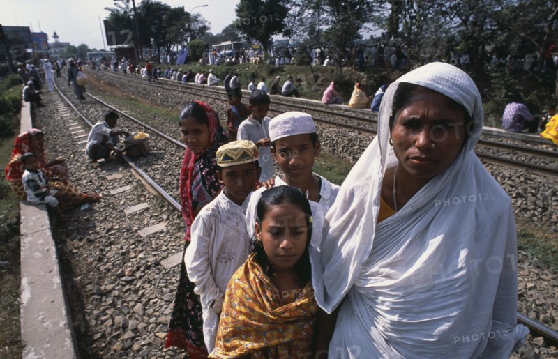 BANGLADESH, Dhaka, Muslim men and women gathered along the railway track at Biswas Ijtema with woman and children in the foreground