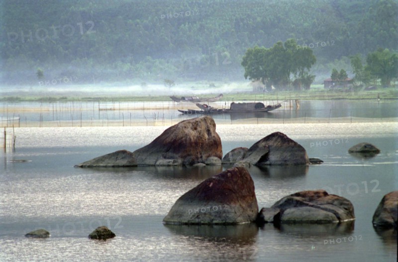 VIETNAM, Central, Lang Co, View over the rocky lagoon with passing boat