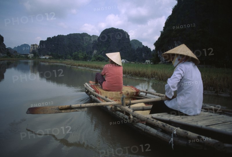 VIETNAM, North, Hoa Lu, Two women rowing bamboo canoe.