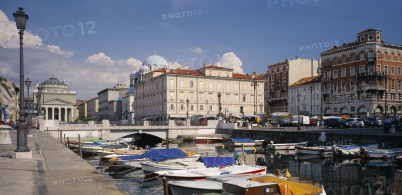 ITALY, Friuli-Venezia Giulia, Trieste, Grand Canale and iew over moored boats toward the waterfront architecture of the city