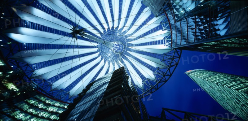 GERMANY, Berlin, Potsdamer Platz. View looking up from the interior of the glass roof of the Sony Centre illuminated at night